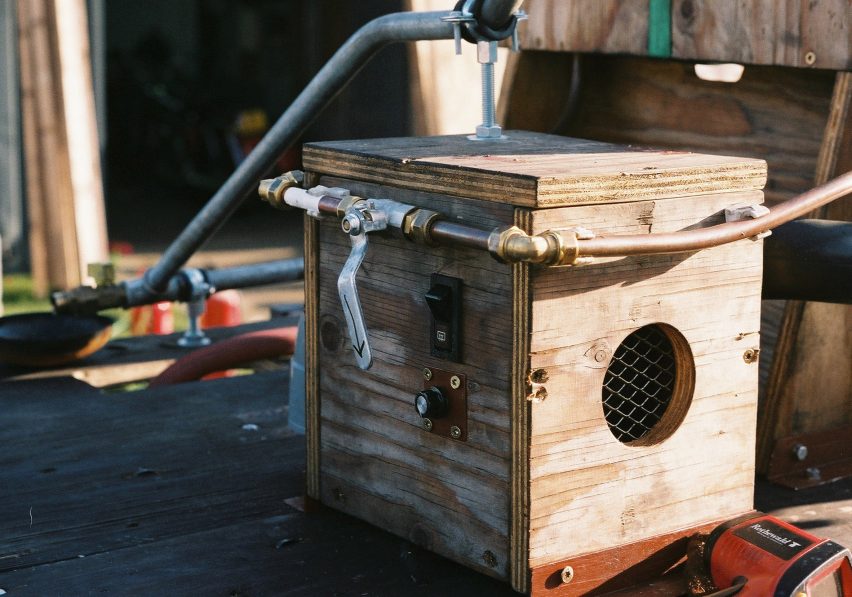 Close-up photo of part of Gijs Schalkx's "de-refinery" showing a wooden box with some simple levers and switches on one side